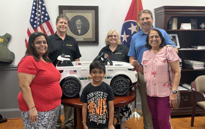 Back L-R: Craig and Anna Nangle, Owners of Tint World Murfreesboro, Sheriff Jeff Hughes and the Naik family.