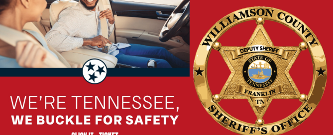 A male and female are sitting in a car and buckling their seatbelts.