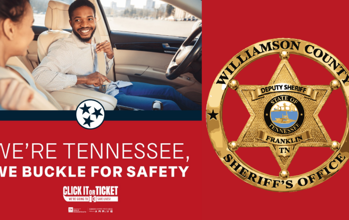 A male and female are sitting in a car and buckling their seatbelts.