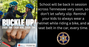 Two kids wearing helmets next to tree with caption "Buckle Up"