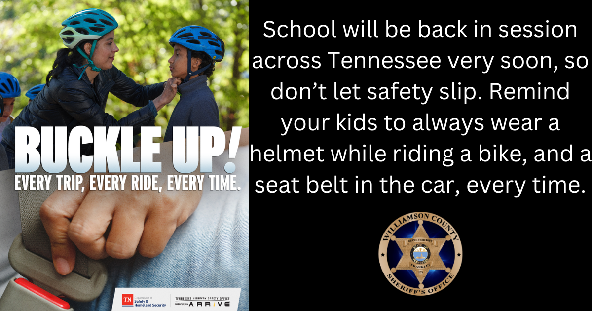 Two kids wearing helmets next to tree with caption "Buckle Up"