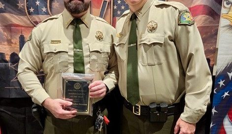 Deputy Josh Beauman stands beside Deputy Chief Matt Gelfand while holding his Deputy of the Year award at the Brentwood Noon Rotary Club’s annual First Responders Picnic. Both are in WCSO uniforms, with a patriotic “Honoring the Heroes” backdrop behind them.